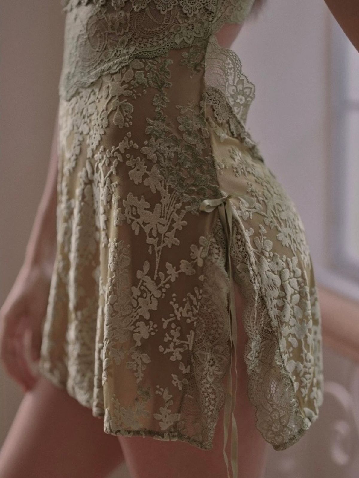 Close-up of a green velvet lace lingerie with a neutral background.