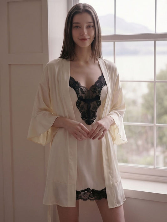 Woman wearing a cream-colored robe over black lingerie in a room with a window.