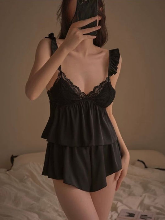 Person wearing a black lace lingerie set taking a mirror selfie.