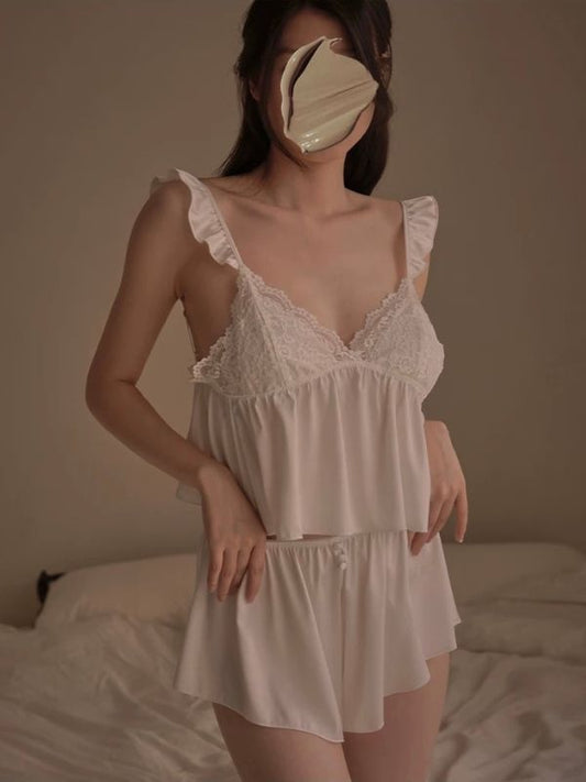 Person wearing a white lace nightgown with a plain background