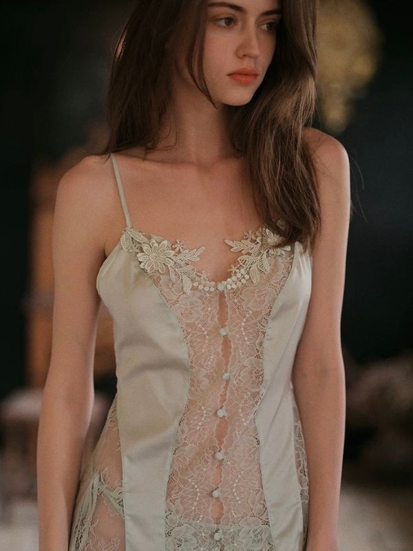 Woman wearing a delicate lace nightgown with a blurred background