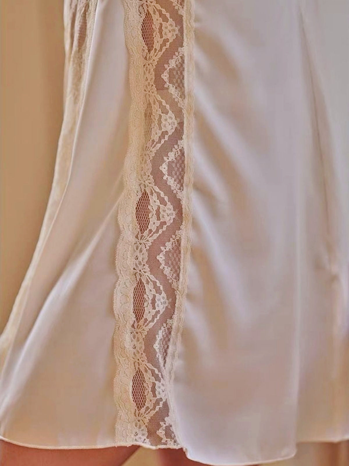 White lace-trimmed garment on a neutral background