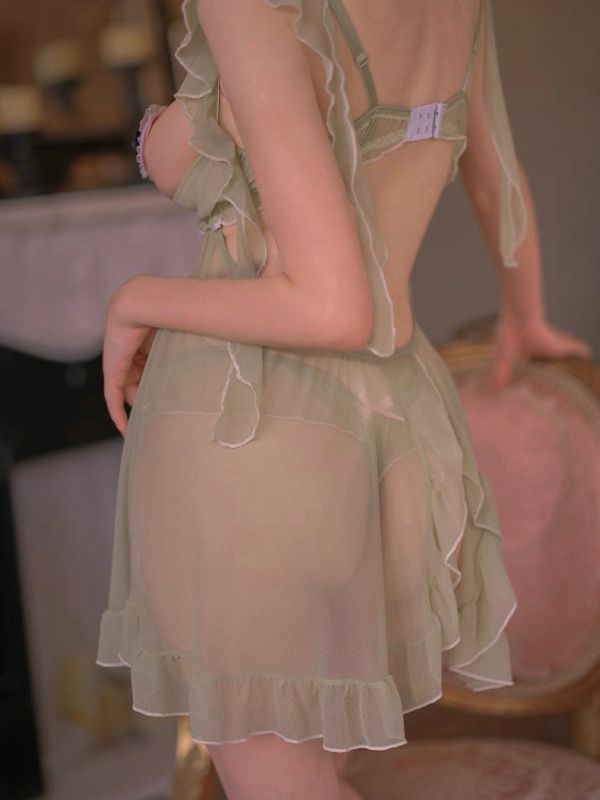 Light green sheer nightgown with ruffled details on a blurred background
