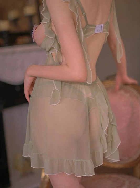 Light green sheer nightgown with ruffled details on a blurred background