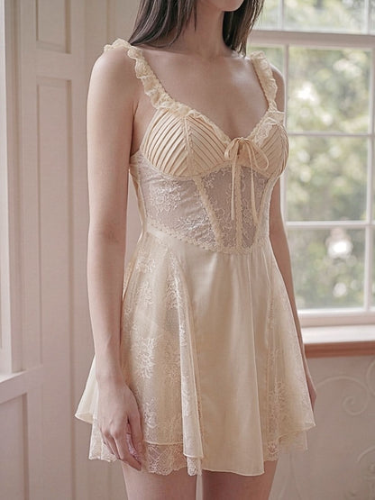 Woman wearing a beige lace nightgown in a softly lit room.